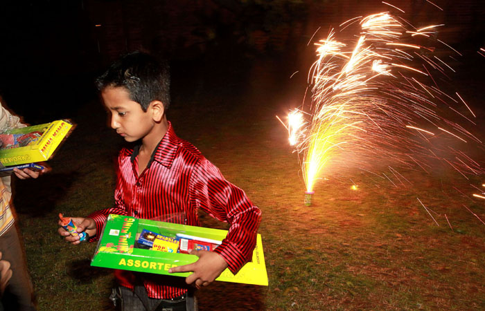 A young boy, near fireworks, set for Diwali, at the residence of the Durban Consul General of India in Durban, South Africa. Close to a billion Hindus celebrated Diwali on Saturday and Sunday. (AP Photo)