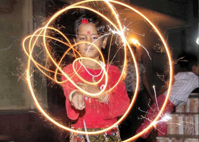 A young girl lights up circles with her sparkler in Bikaner on Diwali. (PTI Photo)