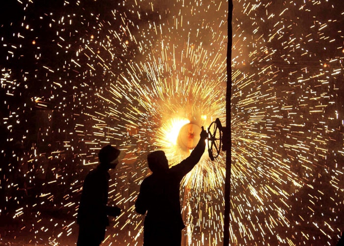 A burst of sparkles as people set of crackers in Gurgaon to celebrate the festival of lights. (PTI Photo)