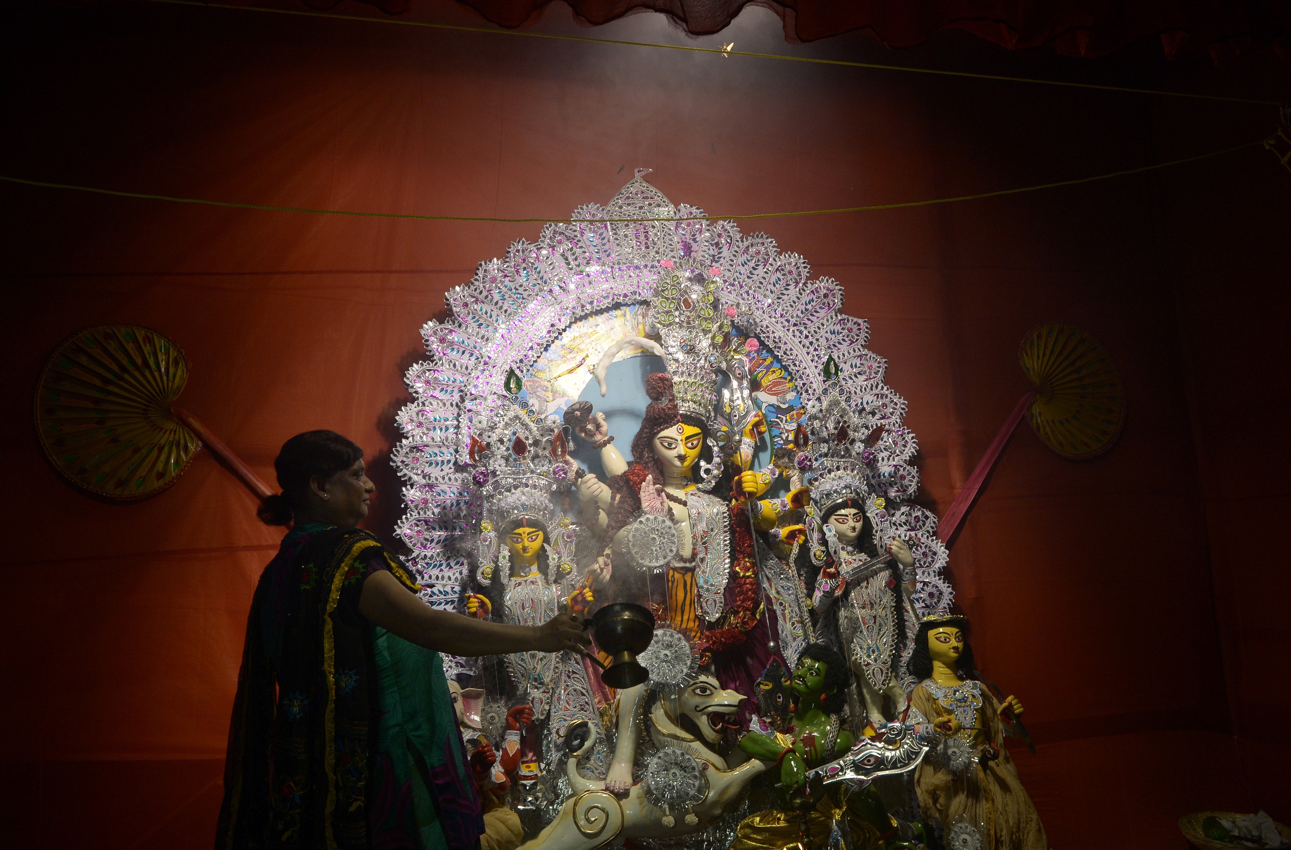 A devotee performs a ritual in front of an idol of Goddess Durga at a pandal in Kolkata.(AFP)