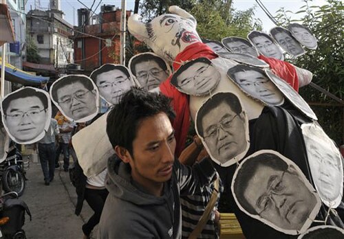 <b>Way to protest:</b> An exiled Tibetan carries an effigy of Chinese President Hu Jintao who is depicted as the Hindu mythological evil king Ravana, to be burnt to mark the Indian festival Dussehra, in Dharmsala. (AP)