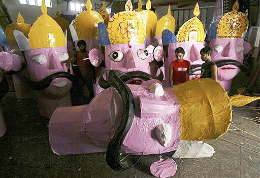 <b>The big effigy:</b> Artists give finishing touches to effigy of the demon King Ravana, for Dussehra festival which marks the culmination of Navratri, or nine nights and a celebration of the victory of good over evil, in Jammu. (AP)