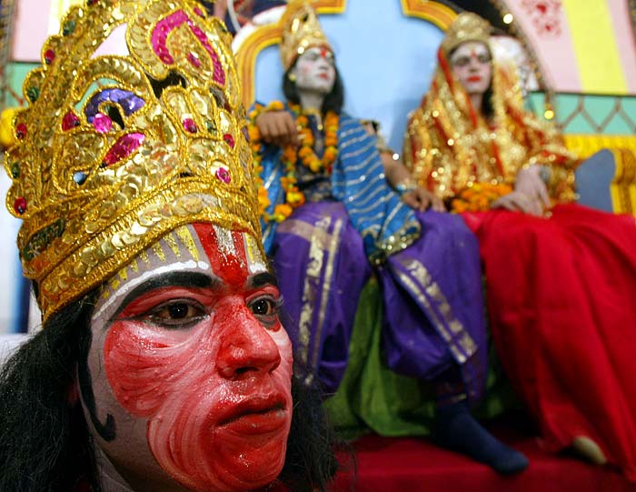 Artists in the role of Hanuman (left) Lord Rama (center) and his wife Sita perform the traditional Ramleela drama on Dusshera in Allahabad.