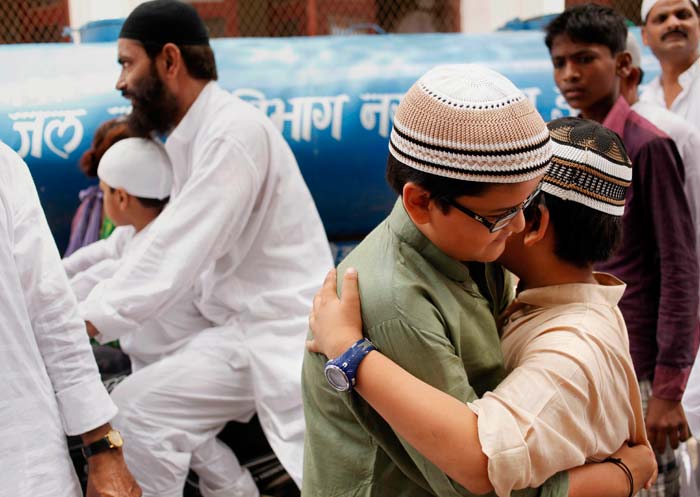 Muslim boys greet each other after offering prayers on Eid-al-Fitr in Allahabad.