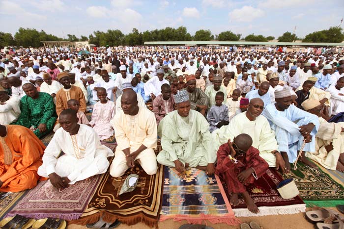 Nigeria Muslim men and boys, offer their prayers during Eid al-Fitr, at Ramat square in Maiduguri, Nigeria.