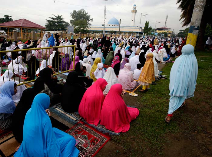 Filipino Muslims attend a prayer at the Blue Mosque to mark the celebration of Eid, the end of holy fasting month of Ramadan.