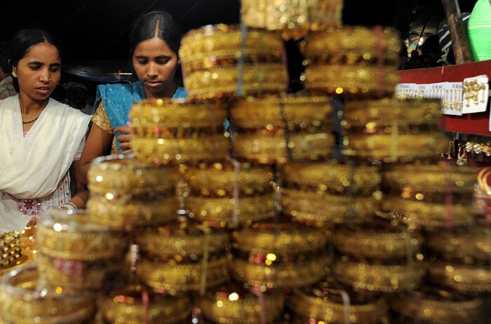 <strong>Gearing up for celebrations:</strong> Muslim girls buy bangles outside the Jama Masjid in New Delhi. <em>(AFP)</em>