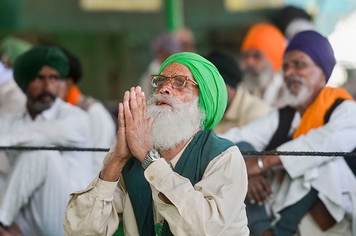 A farmer reacts after PM Modi announced the repealing of the three farm laws, at Singhu border.