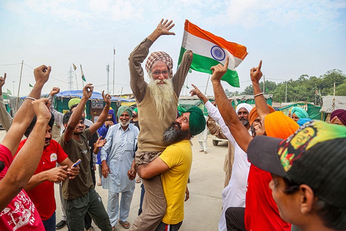 Farmers dance as they celebrate after the three farm laws were repealed, at Tikri Border.