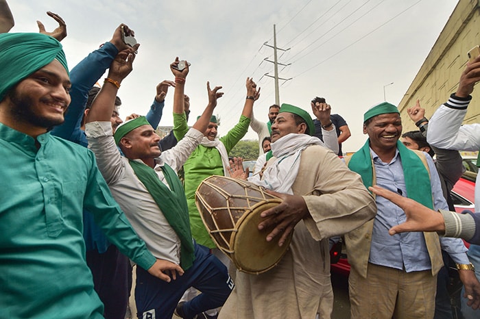Farmers dance and play dhol as they celebrate after the three farm laws were repealed, at Ghazipur Border.