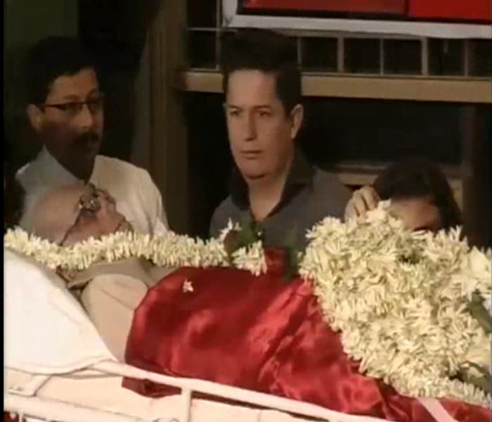 Mourners paused a moment to give the clenched fist salute. Some offered flowers, while others placed garlands and wreaths on it.