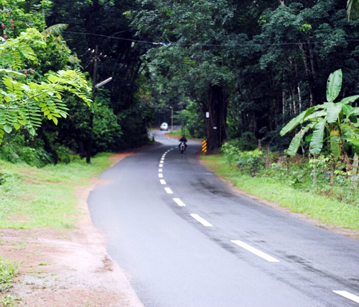 <b>Road trip: </b>A bike and a car travel on a road surrounded by natural beauty. (Image: Ketki Angre)