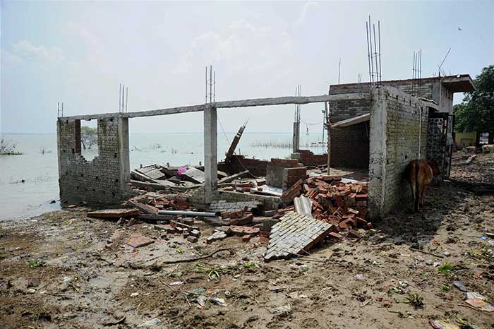 Debris of a house that collasped due to floods at Kailaspuri area of Allahabad on Sunday. (PTI Photo)