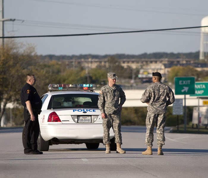 Members of the military and police stand outside Fort Hood. One shooter was killed by military police and at least two other soldiers are in custody. (AFP Photo)