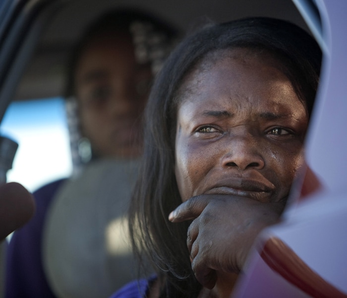 Wife of a soldier, waits outside Fort Hood, At least one gunman killed 12 people and injured 31 in a shooting on a military base at Fort Hood.(AFP Photo)