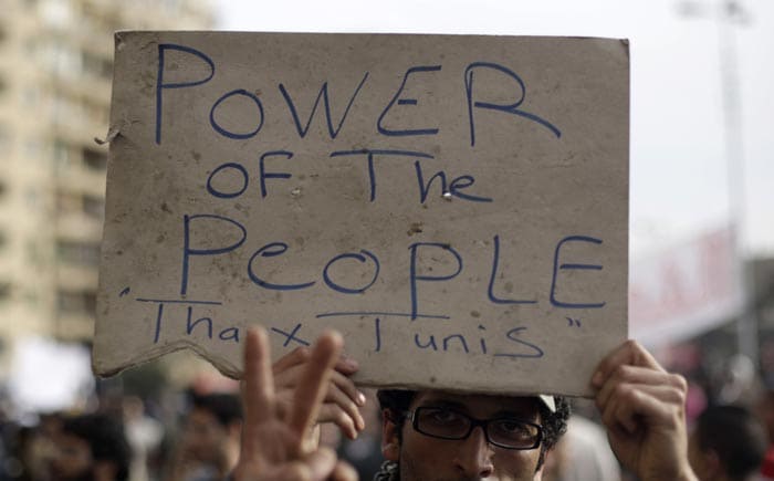 An anti-government protester holds a poster. (AP Photo)