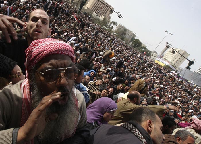 Despite a wider government crackdown, tens of thousands of Egyptians streamed toward the central Tahrir Square on Friday, carrying baskets of bread, food and water for those camped out there and apparently anticipating a long siege to press for the ouster of President Hosni Mubarak. (AP Photo)