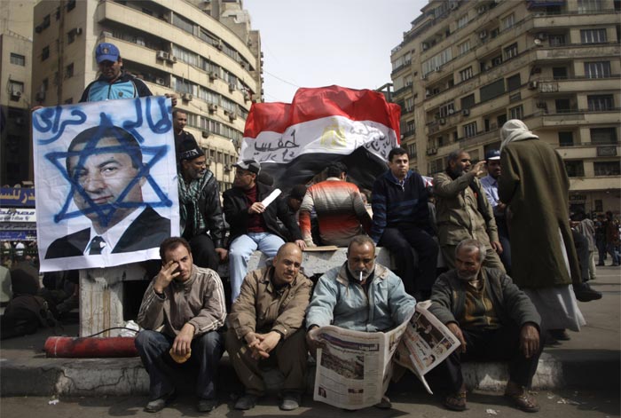 After a night of scattered clashes and bursts of gunfire, an uneasy calm prevailed on Friday as anti-government protesters mustered for what they have called a "Friday of departure" in hopes of maintaining the momentum behind demands that Mr. Mubarak step down after three decades in power. (AP Photo)