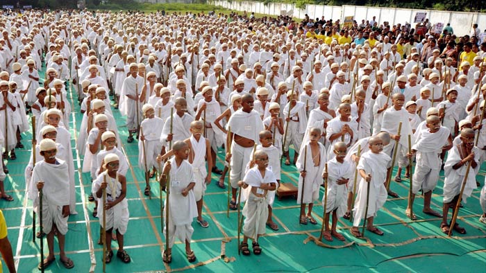 School students, dressed up as Mahatma Gandhi, take part in an event to mark 143rd birth anniversary of the Father of the Nation in Ahmedabad on Monday. (Courtesy: PTI)