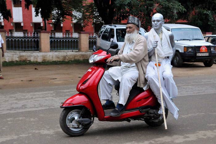 A man dressed as Mahatma Gandhi rides a scooter to participate in a function on the occasion of Gandhi Jayanti in Chikmagalur in Karnataka. (Courtesy: PTI)