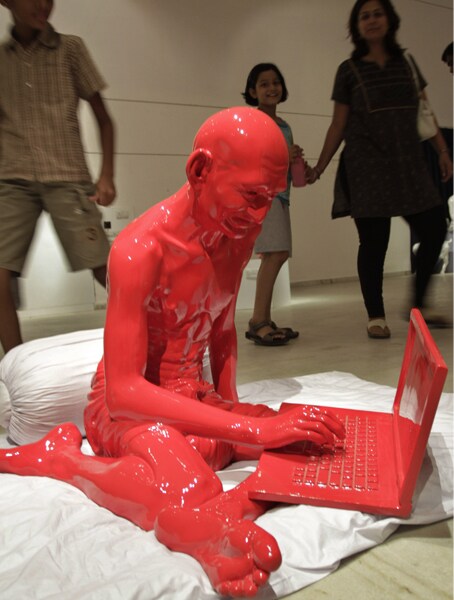 At Ahmedabad, where the Sabarmati Aashram is situated, an exhibition is held every year on the eve of Gandhi Jayanti. This time, the red coloured sculpture of Bapu working on a laptop was a prime attraction.<br> <br> (AP Photo)