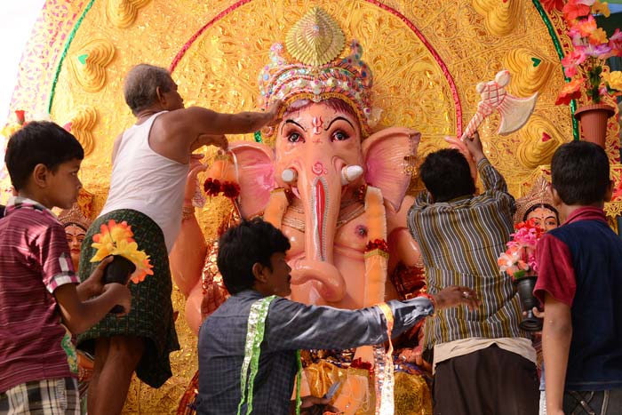 Devotees decorate an idol of lord Ganesh at a temple in Amritsar.