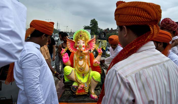 Devotees prepare to carry an idol of lord Ganesh in New Delhi.