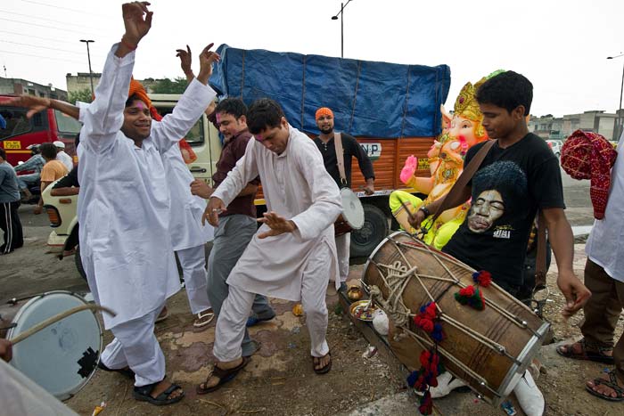 Devotees dance in front of an idol of lord Ganesh in New Delhi.