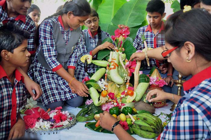 School children using vegetables to make an idol of Lord Ganesh in Moradabad.