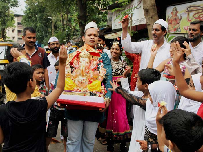 Hindu and Muslims participate in a procession on the occasion on Ganesh Chaturthi in Mumbai.