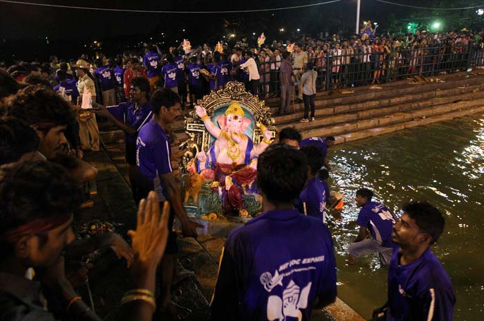 Devotees carry Ganesha idol for immersion in a makeshift pond at Ulsoor lake during the Ganesh Chaturthi celebrations in Bengaluru, Karnataka.