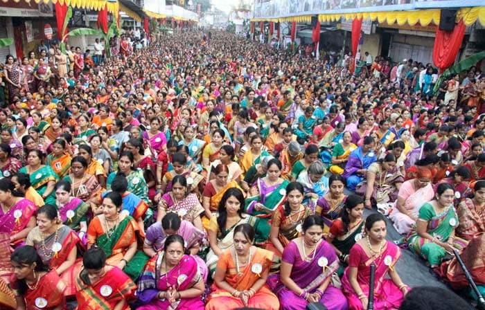 Women devotees participate in a mass prayer at Dagusheth Ganapati Pandal in Pune during Ganeshotsav.