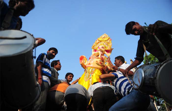 Devotees carry an idol of lord Ganesh on the occasion of the Ganesh Chaturthi festival in Allahabad.