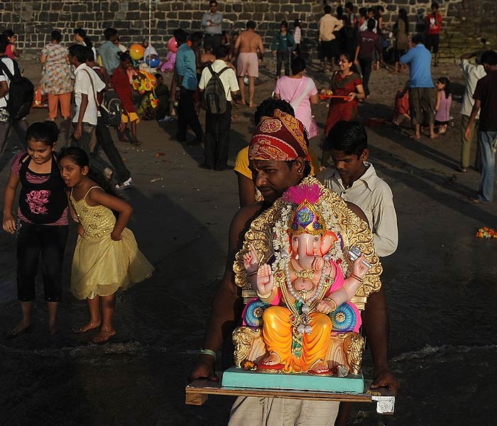 Thousands of people gathered for the Ganesh visarjan ceremonies that got off to a peaceful start in Mumbai. The police, Navy and the Coast Guard provided aerial, sea and land security cover, officials said. (AFP Photo)<br><br><b>Be an I-Witness</b><br><br>You too can share your story through photos and videos. Just upload them here and we'll feature the best entries on NDTV.com.<br><br><iframe  src="http://www.ndtv.com/convergence/ndtv/new/iframe_NDTVShowUpload.aspx?Template=iwitness&ReqEmail=1&ShowCity=1&ReqCity=1&type=a&ShowDisclaimer=0"  width="400" height="200"  scrolling="no" frameborder="0"> </iframe>