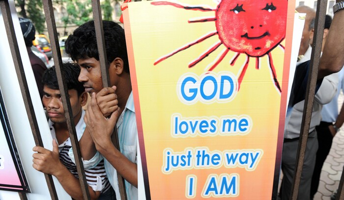 Bystanders watch members of the lesbian, gay, bisexual and transgender community participate in the celebrations in Mumbai. (AFP Photo)