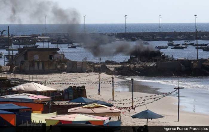 Smoke billows from a beach shack following an Israeli military strike, on July 16, 2014 in Gaza City which killed four children, medics said.