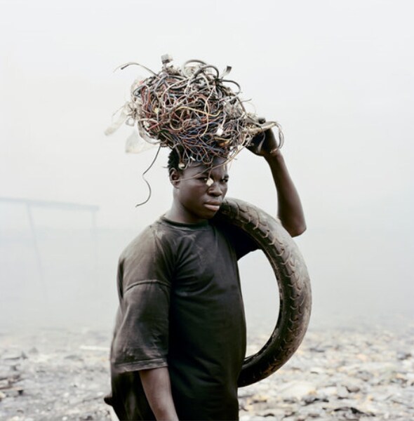 Yakubu Al Hasan, 20, with computer extractions. Copper is perhaps the most desirable, then brass, then aluminum, then zinc. (Photo credit: Pieter Hugo for The New York Times)