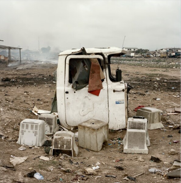 Computer monitors sometimes double as chairs at the Agbogbloshie dump. (Photo credit: Pieter Hugo for The New York Times)