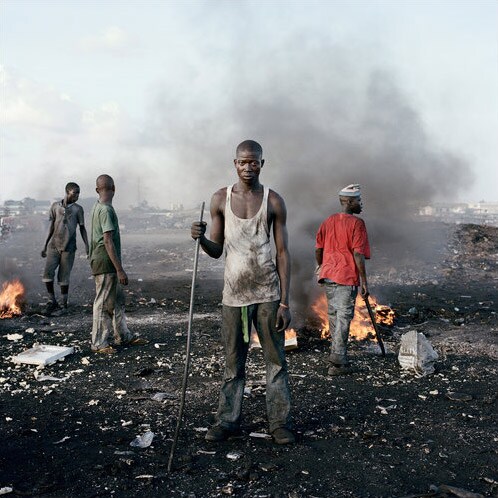 In Agbogbloshie, a slum in Accra, the capital of Ghana, adults and children tear away at computers from abroad to get at the precious metals inside. Left, 18-year-old David Akore and other foragers. (NYT Photo)