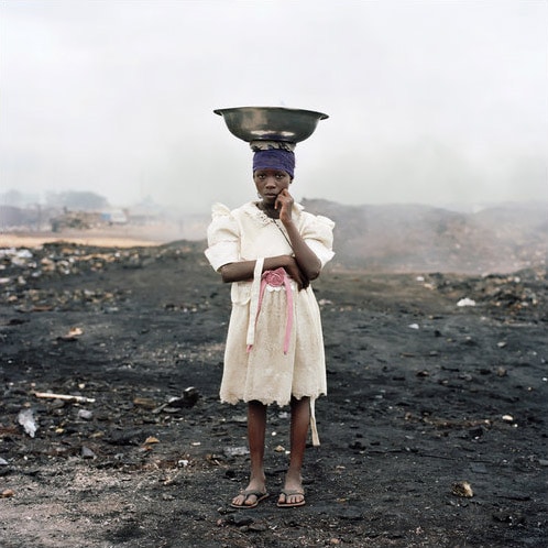 11-year-old Naasra Yeti, one of the scavengers in the Agbogbloshie Market. Women and girls often carry bowls of ice to put out fires. (NYT Photo)