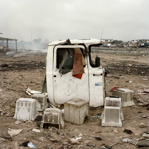 Computer monitors sometimes double as chairs at the Agbogbloshie dump. (NYT Photo)