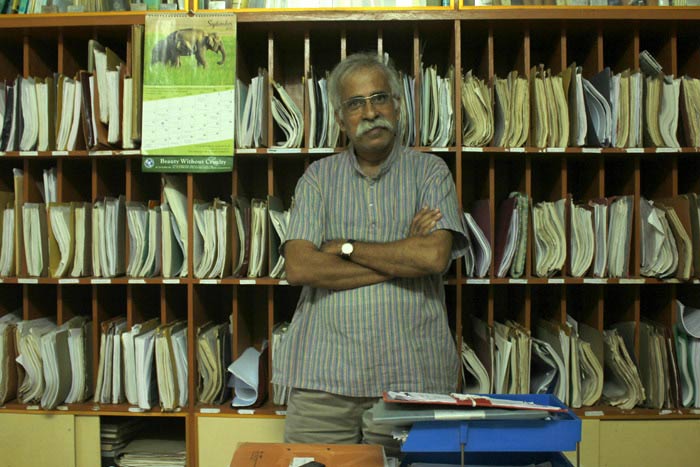 Claude Alvares of the Goa Foundation, at his office in Mapusa. The shelves behind Alvares are filled with ongoing and past court cases against many environmental violations, mining being the biggest at the moment.