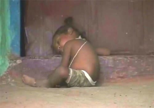 <span class="lh16 fa fs12 fb"><strong>A life less secure:</strong> A devadasi's child asleep on the threshold.</span>