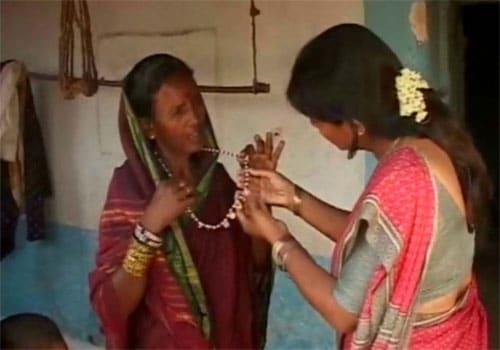 <span class="lh16 fa fs12 fb"><strong>Wedded to the gods:</strong> Huligamma shows her 'thaali'</span>