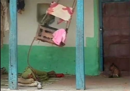 <span class="lh16 fa fs12 fb"><strong>Wind-blown:</strong> A mother rocks the cradle as her other child sleeps on the threshold.</span>