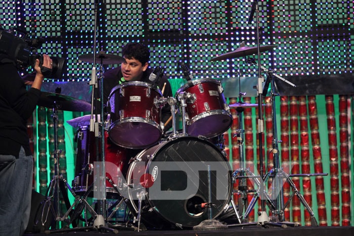 Cyrus tries his hands at drums.