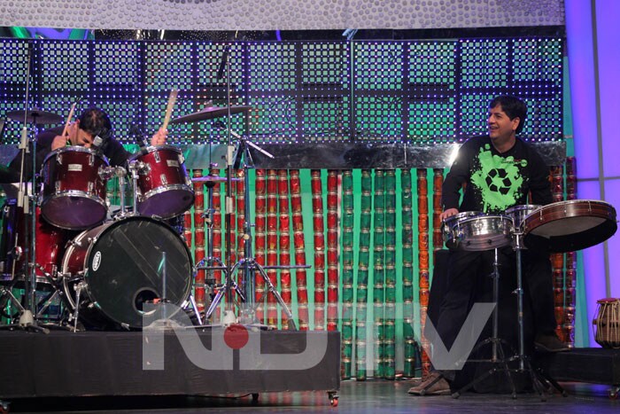 Cyrus, Vikram playing drums.