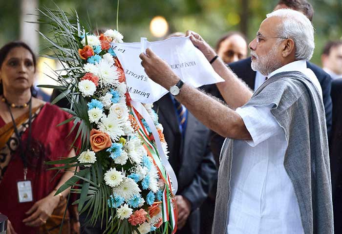 Prime Minister Narendra Modi laying a wreath at the survival tree at Ground Zero, the 9/11 memorial, in New York, USA on Saturday. (Press Trust of India photo)
