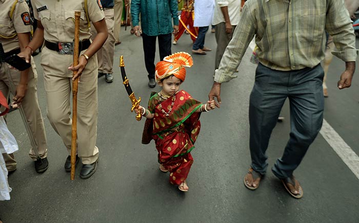 A child dressed in traditional attire takes part in a procession celebrating 'Gudhi Padwa', the Maharashtrian new year in Mumbai.