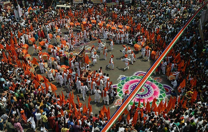 Participants dressed in traditional attire dance during a procession celebrating 'Gudhi Padwa' in Mumbai.